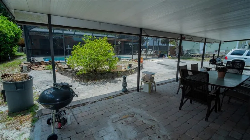 View of patio / terrace with a grill and glass enclosure