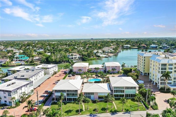 Home is on the first floor, Bay side with Gulf Access.  Located in the first pink building on the right.