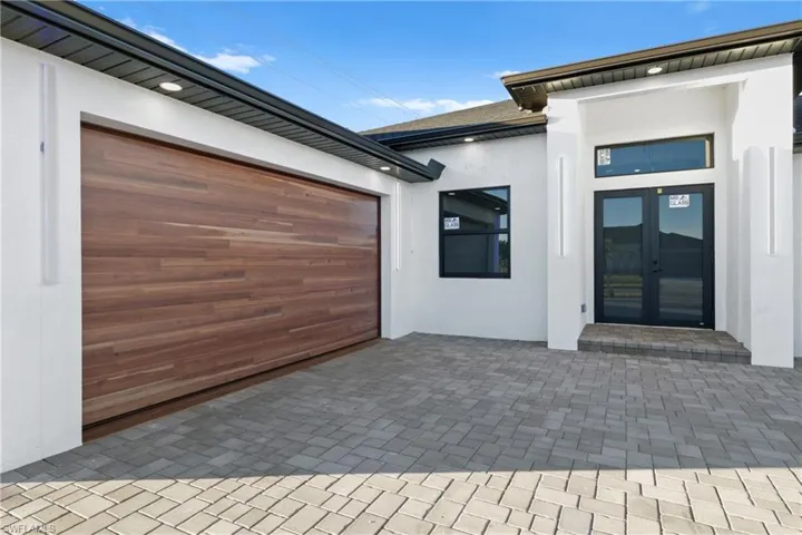 View of patio / terrace with a garage and french doors