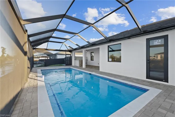 View of swimming pool featuring a lanai and a patio