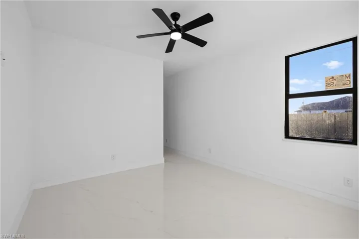 Spare room featuring a mountain view and ceiling fan