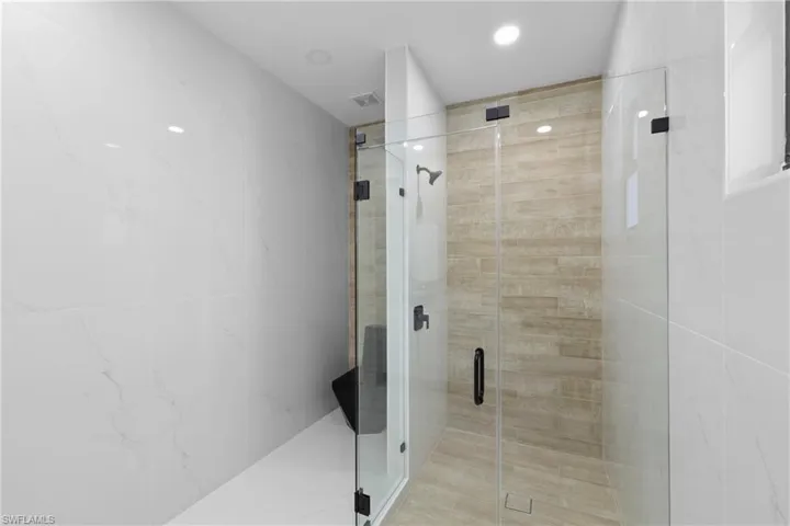 Bathroom featuring a shower with door