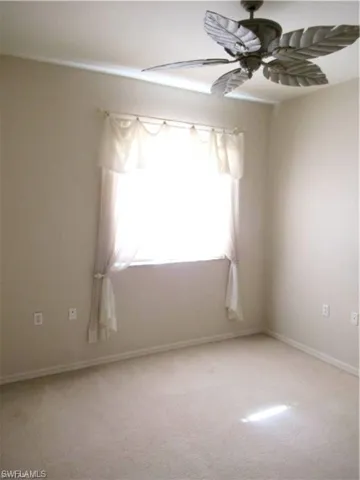 Neutral-toned walls complement light-colored carpeting.