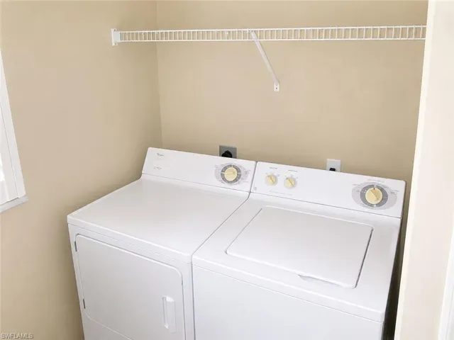 Dedicated laundry area featuring a white wire shelving unit and light beige wall paint