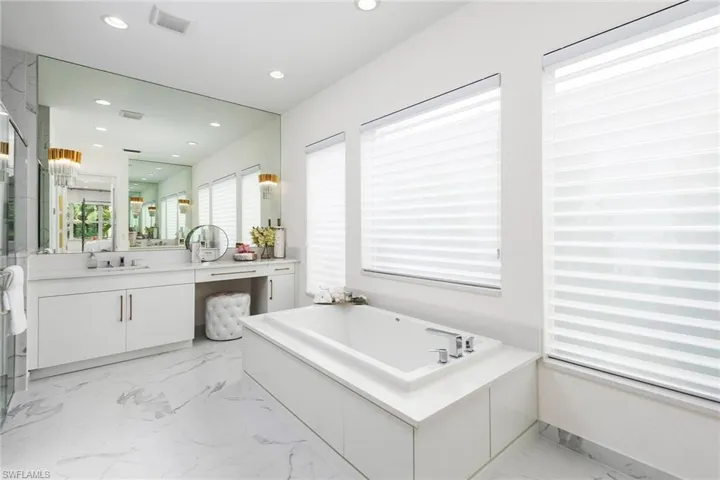 Bathroom featuring a tub and vanity
