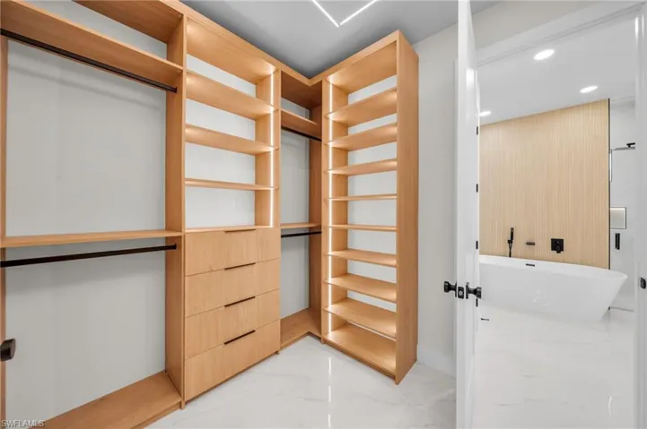 Spacious closet with marble finish floor