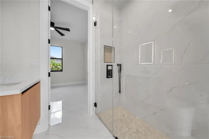Hallway featuring baseboards and marble finish floor