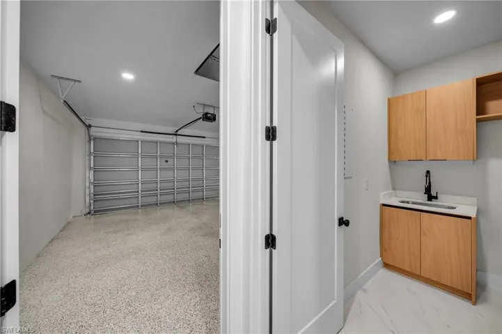 Garage with recessed lighting and a sink