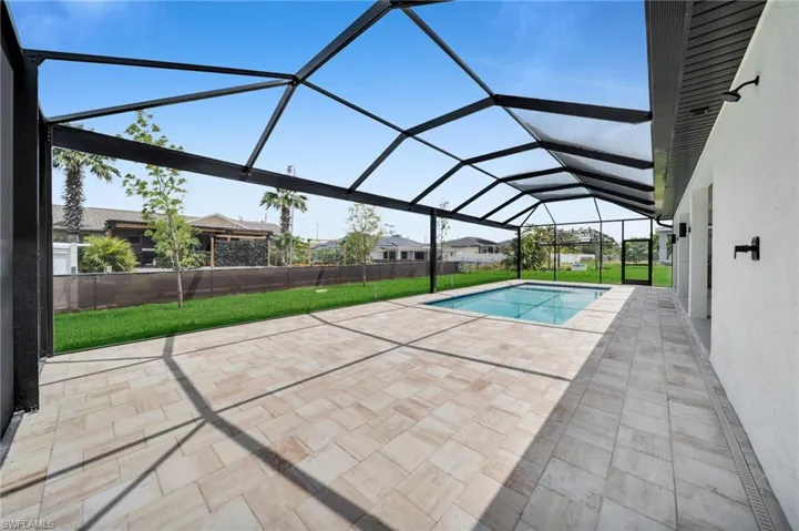 Pool featuring a yard, a patio, and a lanai