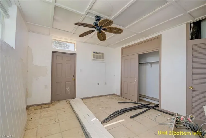 Foyer entrance with ceiling fan and a wall mounted air conditioner