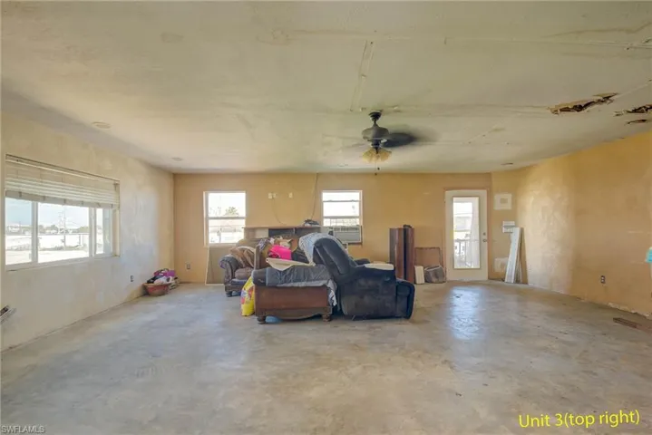 Sitting room featuring concrete floors and a ceiling fan