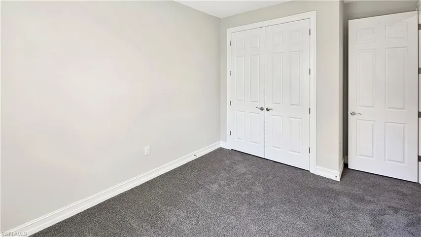 Unfurnished bedroom featuring carpet floors and a closet