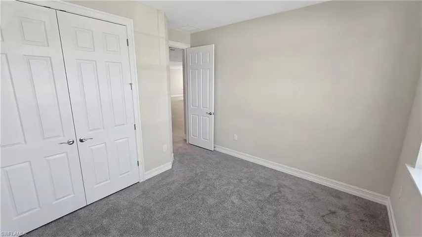 Unfurnished bedroom with carpet floors and a closet