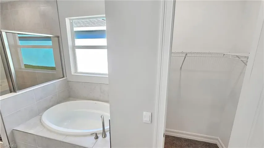 Bathroom featuring tiled bath