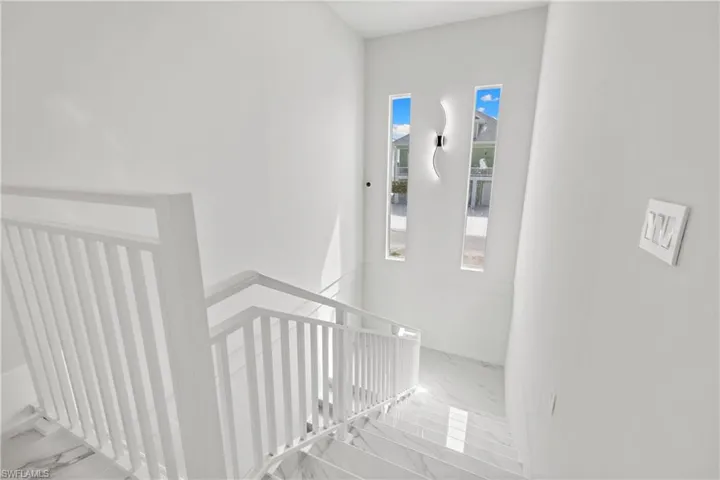 Stairs featuring marble look tile flooring