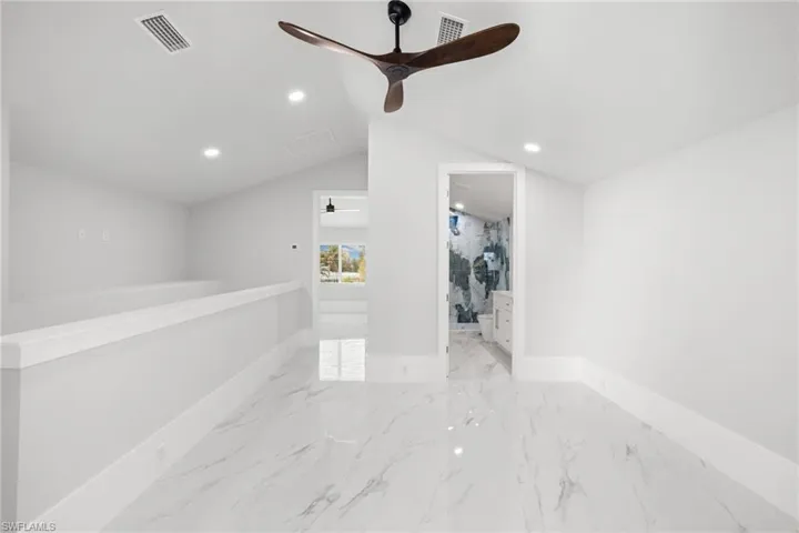 Empty room featuring recessed lighting, ceiling fan, and light marble finish floors