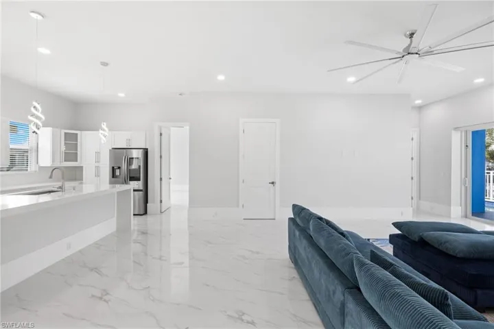 Living area featuring ceiling fan and recessed lighting