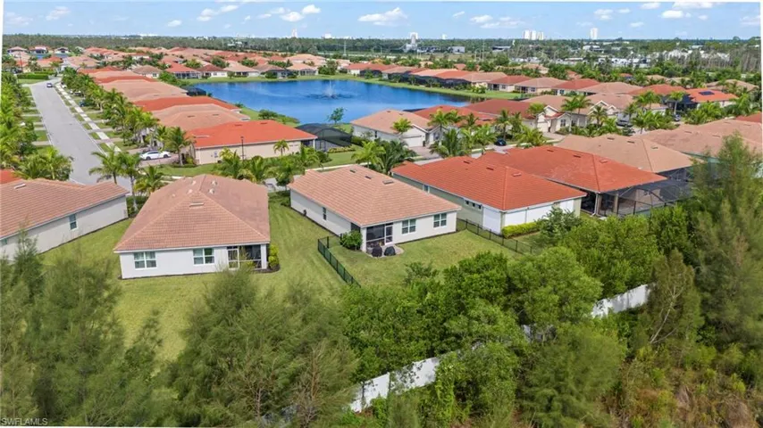 Birds eye view of property with a water view