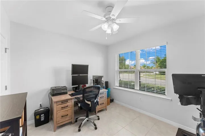 Tiled Bedroom featuring ceiling fan