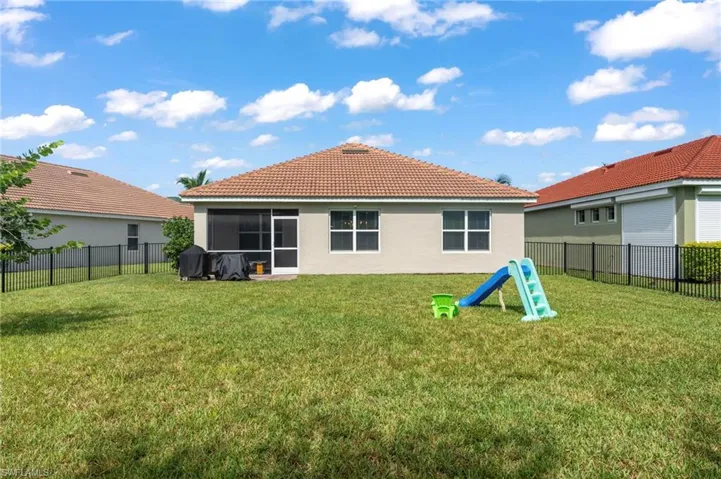 Rear view of house with a yard