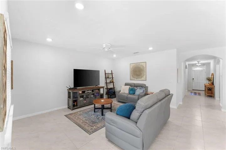 Living room featuring ceiling fan and light tile patterned floors