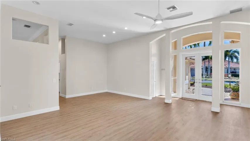 Foyer entrance featuring french doors, a ceiling fan, light wood-style flooring, a high ceiling, and recessed lighting