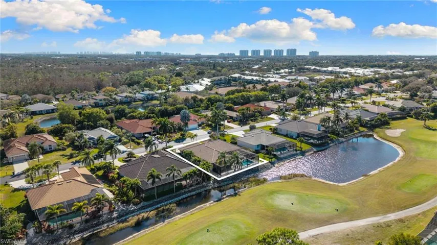 Aerial perspective of suburban area featuring a large body of water, a local golf course, and skyline