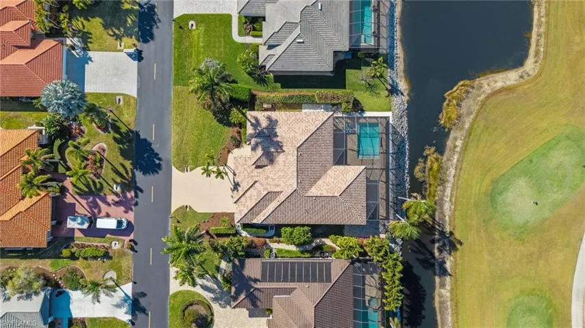 Drone / aerial view of a local golf course and a nearby body of water