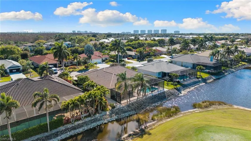 View of urban area featuring a nearby body of water, nearby suburban area, and a local golf course