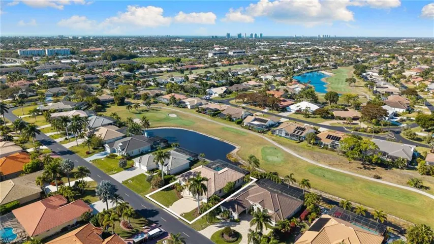 View of urban area with a large body of water, a golf club, and nearby suburban area