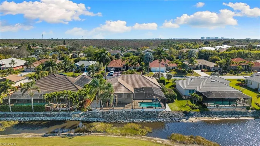 Aerial perspective of suburban area featuring a large body of water