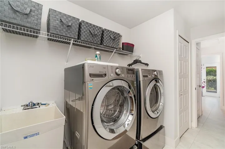 Laundry area featuring washer and dryer and tile patterned flooring