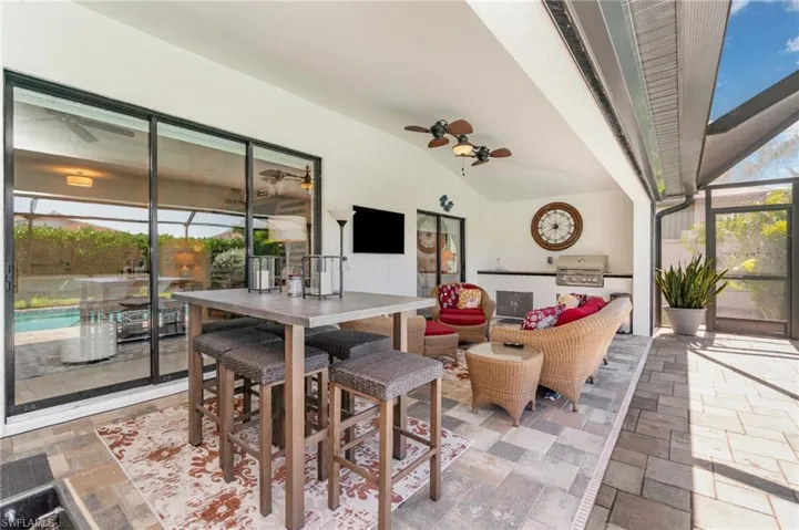 View of patio / terrace with a sunroom, area for grilling, and a lanai