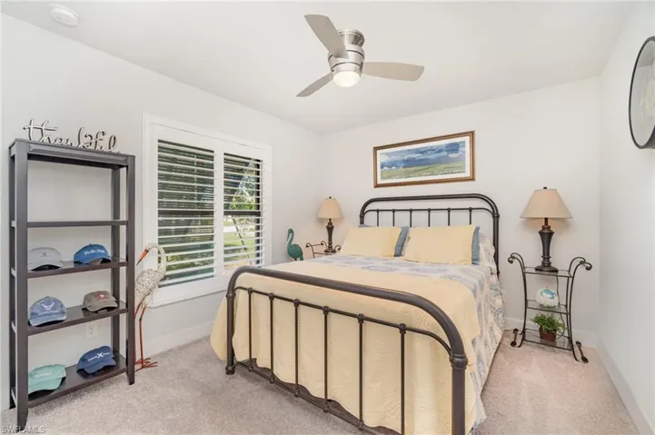 Bedroom with light carpet and ceiling fan