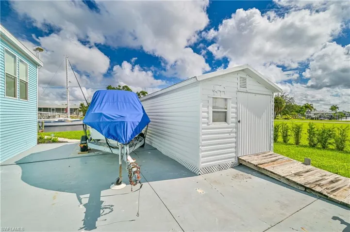 View of outbuilding with a yard