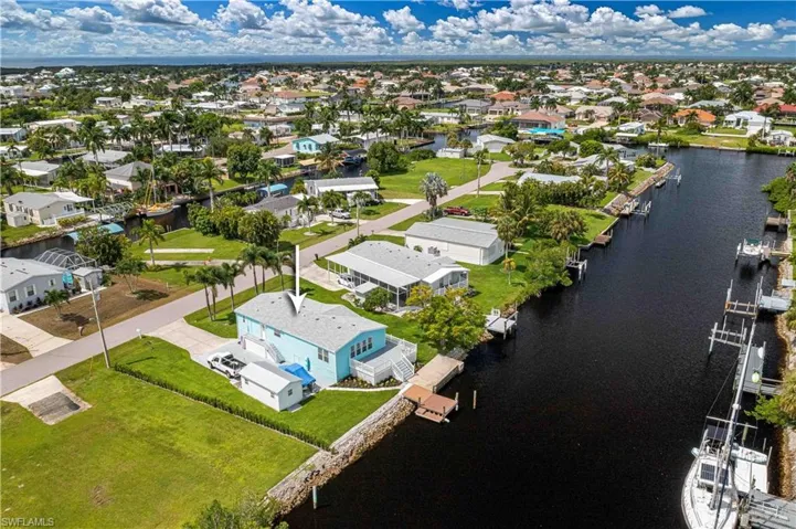 Birds eye view of property with a water view