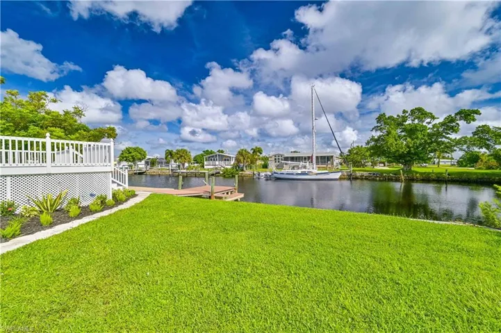 View of yard featuring a deck with water view