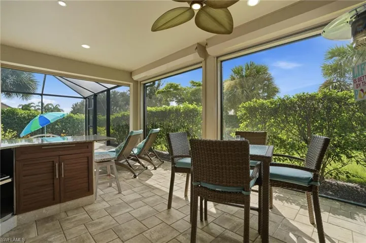 Sunroom / solarium with outdoor dining area, ceiling fan, and a patio area
