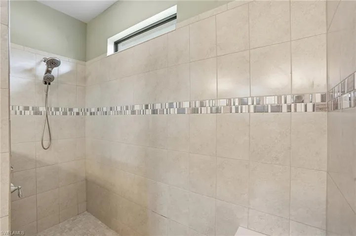 Bathroom featuring tiled shower