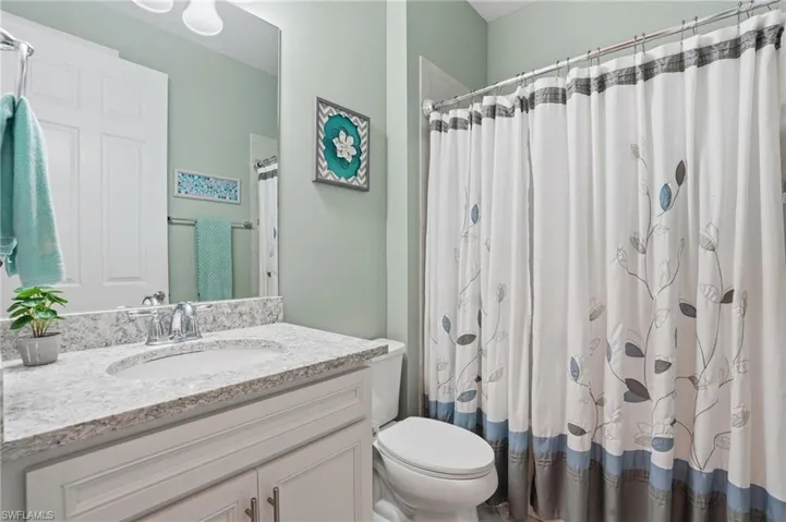 Full bathroom featuring vanity and a shower with shower curtain