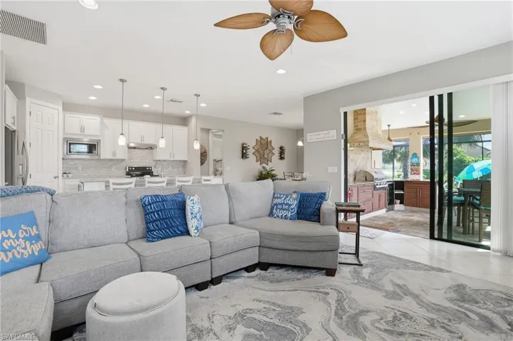 Living area with recessed lighting, a ceiling fan, and light tile patterned floors