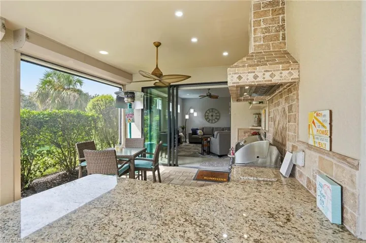 Kitchen featuring light stone counters and recessed lighting