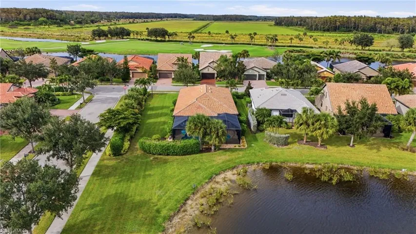 Aerial perspective of suburban area featuring a nearby body of water