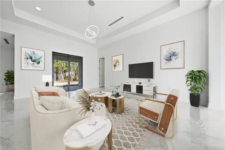 Living area with recessed lighting and a tray ceiling