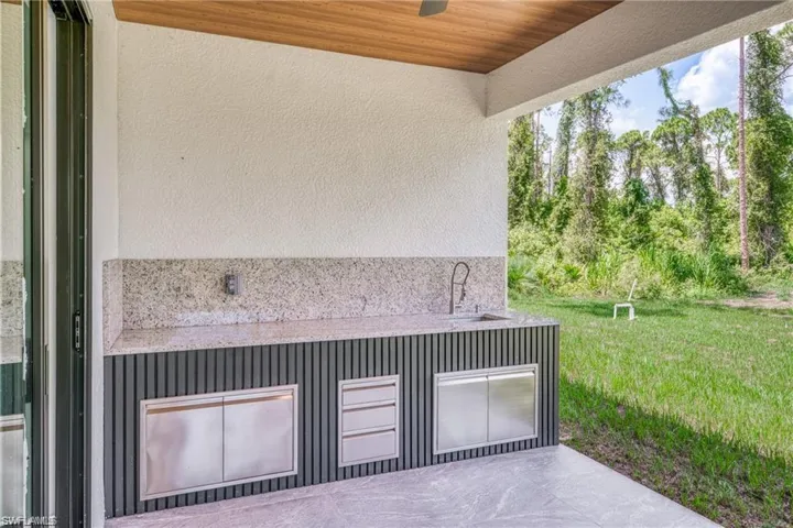 View of patio with a sink and a ceiling fan