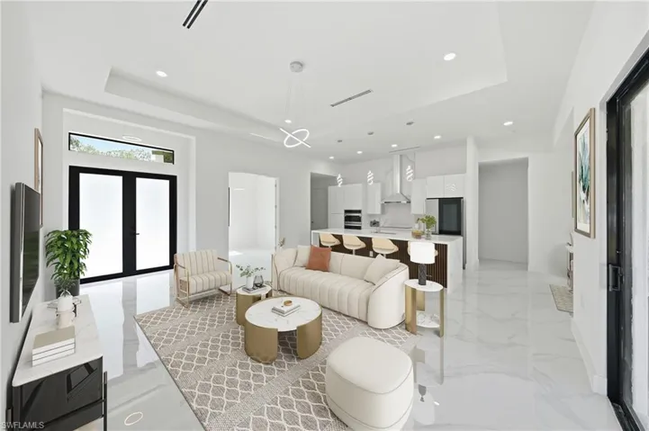 Living area with recessed lighting and a tray ceiling