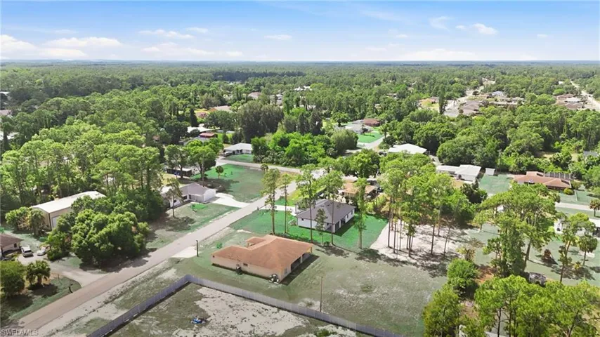 Expansive aerial rendering showcasing multiple residential properties surrounded by mature trees and lush green landscaping