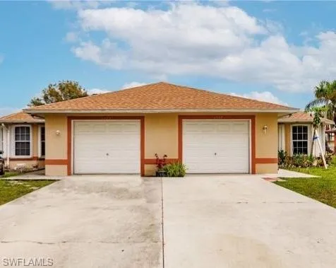 Ranch-style home featuring stucco siding, concrete driveway, a garage, and a shingled roof