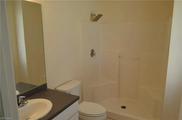 Bathroom with vanity and a tile shower