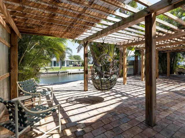 View of patio with a water view and a pergola